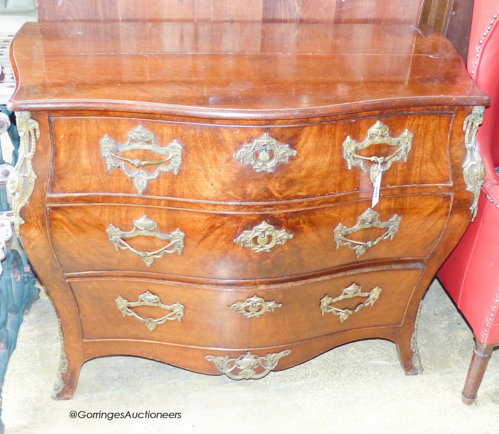 A 19th century Dutch gilt metal mounted mahogany bombe commode. W-110, D-55, H-83cm.